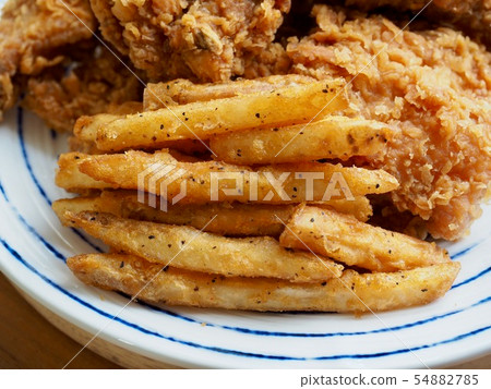 Fried chicken, French fries and vegetables Fried chicken, French fries and vegetables 54882785
