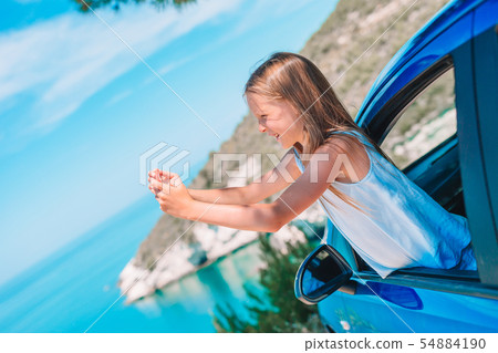 Little girl on vacation travel by car. Summer holiday and car travel concept Little girl on vacation travel by car. Summer holiday and car travel concept 54884190