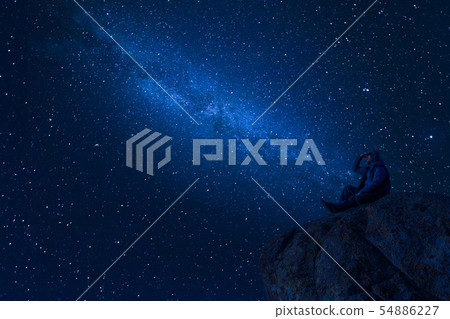 Mountaineer look at night sky with stars 54886227