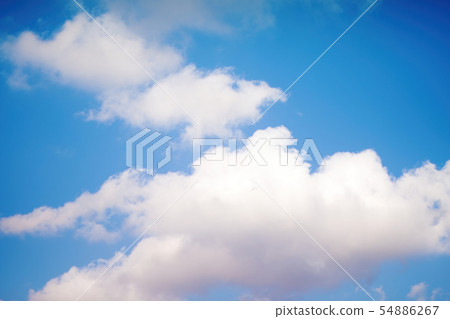 White and gray fluffy clouds against the blue sky White and gray fluffy clouds against the blue sky 54886267