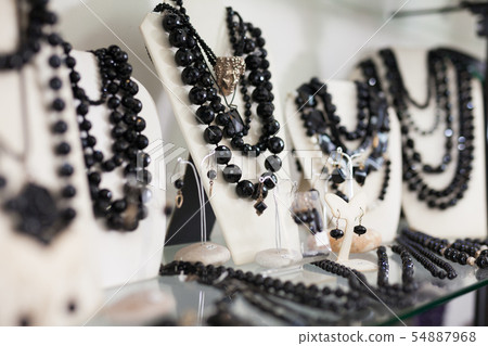 Counter with onyx jewelry in store 54887968