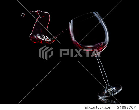 Glass for red wine with splashes isolated on black background. Glass for red wine with splashes isolated on black background. 54888707