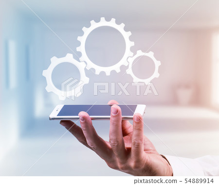 Hand of businessman holding smartphone with cogwheel. 54889914
