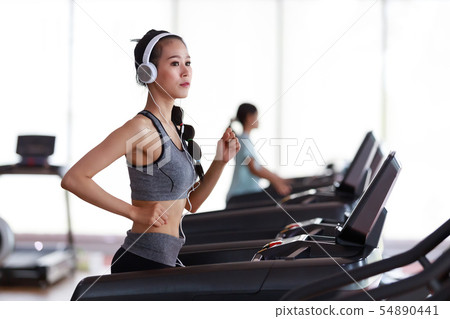 Fitness woman wearing headphone cardio workout at 54890441