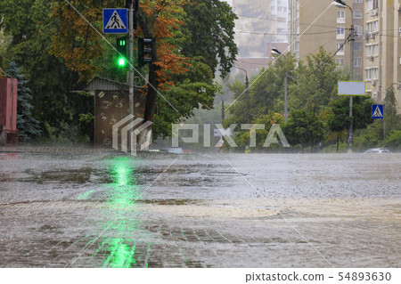 Heavy rain on the sidewalk and asphalt road 54893630