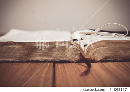 Vintage tone of a Bible with headphones. Vintage tone of a Bible with headphones. 54895117