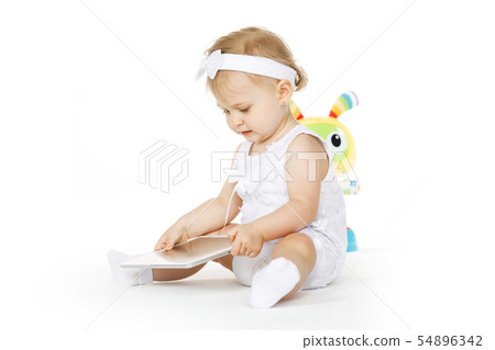 little girl all in white with tablet and toy little girl all in white with tablet and toy 54896342