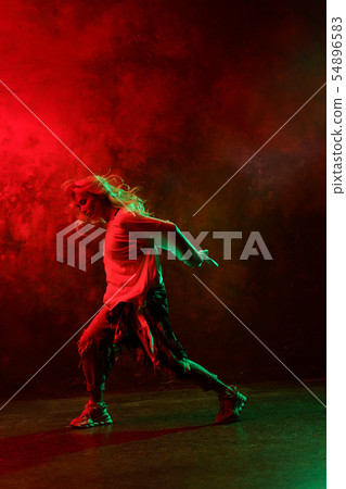 Photo of side of dancing woman on green-green background Photo of side of dancing woman on green-green background 54896583