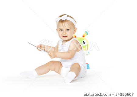 little girl all in white with tablet and toy little girl all in white with tablet and toy 54896607
