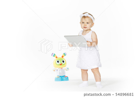 little girl all in white with tablet and toy 54896681