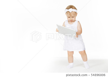 little girl all in white with a tablet little girl all in white with a tablet 54896806