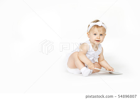little girl all in white with a tablet 54896807