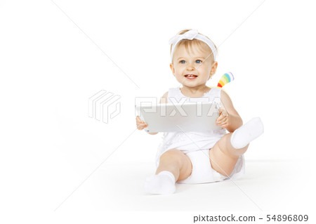 little girl all in white with tablet and toy little girl all in white with tablet and toy 54896809