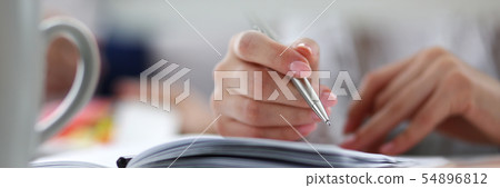 Letterbox of female executive holding silver pen in hands Letterbox of female executive holding silver pen in hands 54896812
