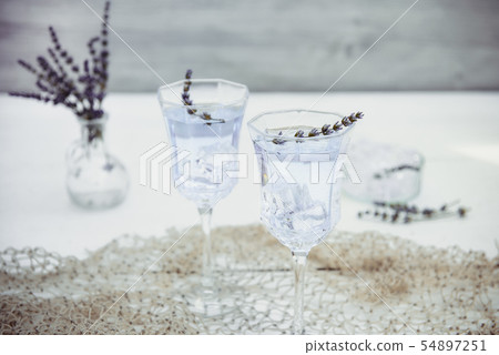 Fresh lavender lemonade with flowers and ice cubes Fresh lavender lemonade with flowers and ice cubes 54897251
