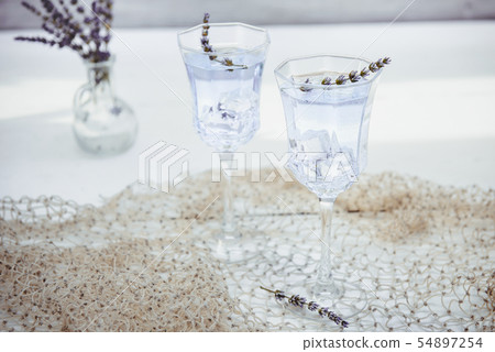 Fresh lavender lemonade with flowers and ice cubes Fresh lavender lemonade with flowers and ice cubes 54897254