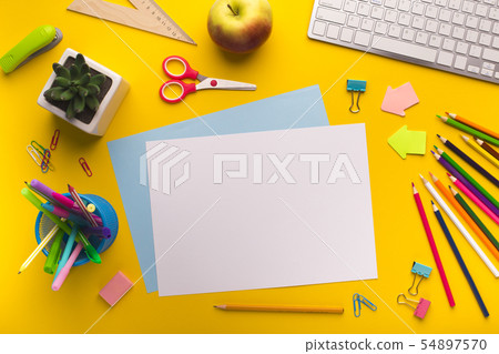 Diversed Office supplies mess on yellow background 54897570