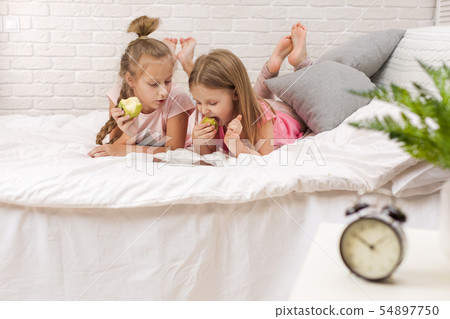 two little kids girls play in the bedroom 54897750