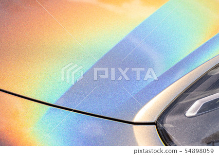 Close-up LED headlight expensive car part with exclusive iridescent painting. Vehicle covered with Close-up LED headlight expensive car part with exclusive iridescent painting. Vehicle covered with 54898059