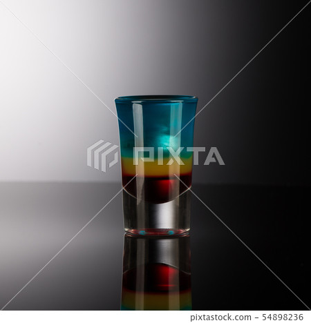 shot glass with alcohol on a dark background 54898236
