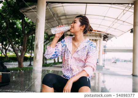 Asian athlete drinking water Asian athlete drinking water 54898377