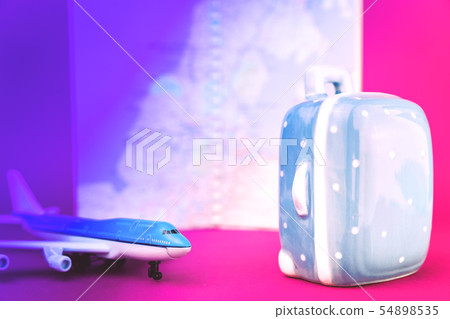 Pink violet aircraft and suitcase travel concept 54898535