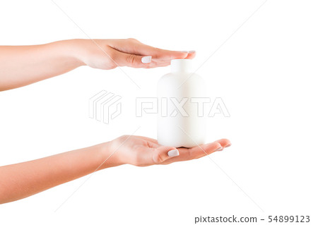 Female hand holding cream bottle of lotion Female hand holding cream bottle of lotion 54899123