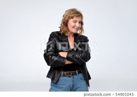 Mature pretty european woman in black leather jacket. Mature pretty european woman in black leather jacket. 54901043