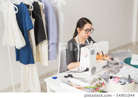 People, tailor and fashion concept - High angle view portrait of smiling fashion designer in glasses People, tailor and fashion concept - High angle view portrait of smiling fashion designer in glasses 54901044