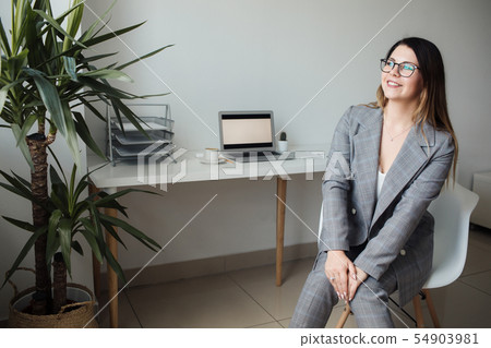 younger girl working in the office at the table younger girl working in the office at the table 54903981