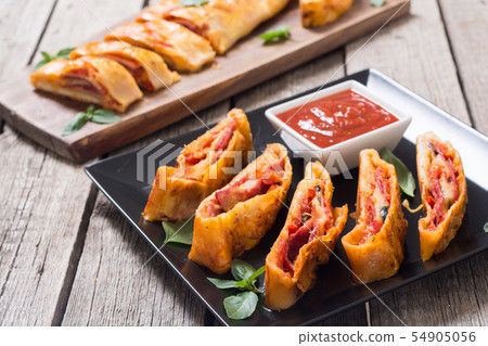 Pizza roll stromboli with cheese salami olives and 54905056