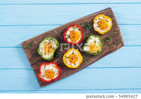 Yellow , red and green pepper with fried eggs 54905427