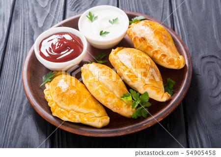 Latin American baked beef empanadas with sauce Latin American baked beef empanadas with sauce 54905458