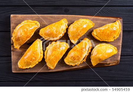 Latin American baked beef empanadas with sauce Latin American baked beef empanadas with sauce 54905459