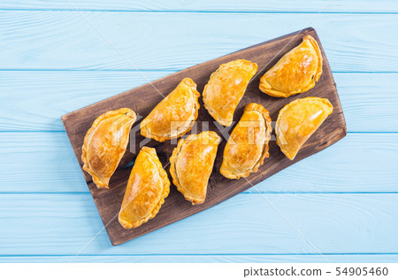 Latin American baked beef empanadas with sauce 54905460