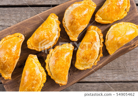 Latin American baked beef empanadas with sauce 54905462