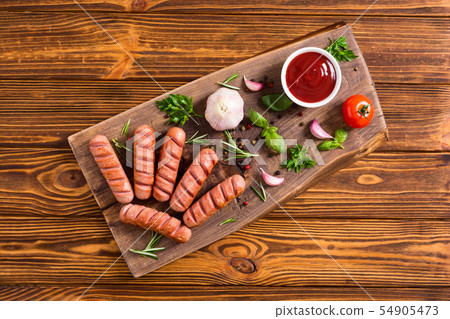 Fried sausages with herbs , spices and ketchup 54905473
