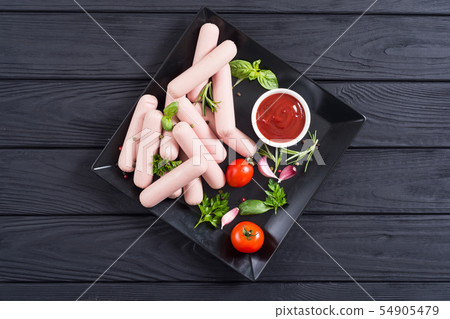 Raw beef sausages with pepper , herbs and ketchup 54905479