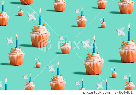 Big and small cupcakes with lit candles 54906491