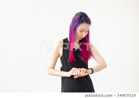 Asian young woman using activity tracker indoors 54907019