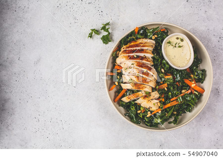 Grilled chicken breast salad with kale, pine nuts 54907040