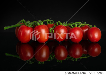 Red cherry tomato isolated on black glass Red cherry tomato isolated on black glass 54907286