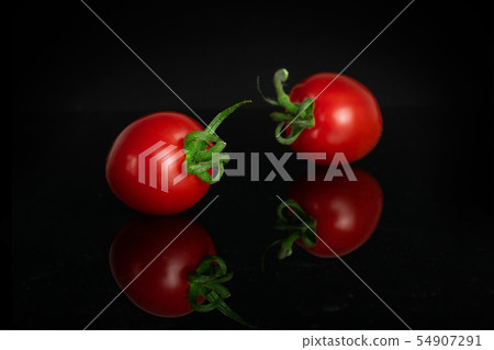Red cherry tomato isolated on black glass 54907291