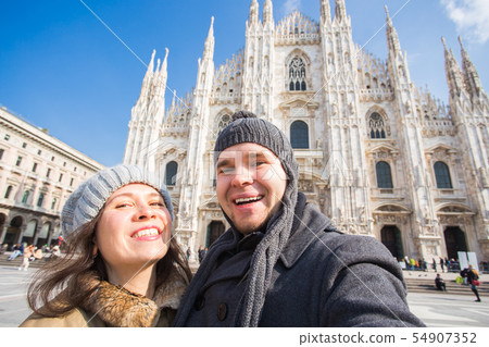 Travel, photographing and people concept - Happy couple taking self portrait in Milano in Duomo Travel, photographing and people concept - Happy couple taking self portrait in Milano in Duomo 54907352