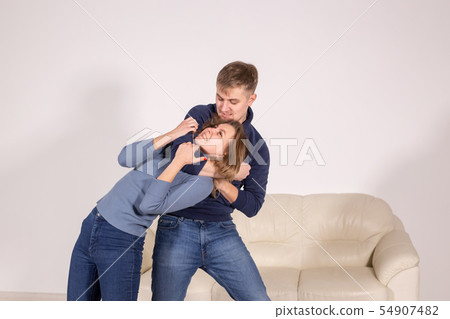 people, abuse and violence concept - agressive man strangling his wife people, abuse and violence concept - agressive man strangling his wife 54907482
