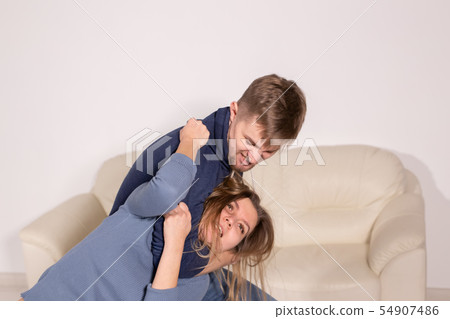People, abuse and violence concept - aggressive man strangling his wife People, abuse and violence concept - aggressive man strangling his wife 54907486