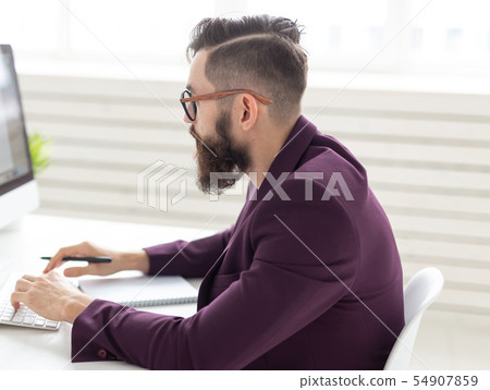 People and technology concept - Side view portrait of handsome man dressed in purple jacket working People and technology concept - Side view portrait of handsome man dressed in purple jacket working 54907859