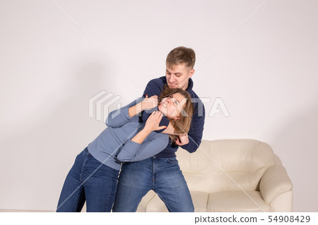 people, abuse and violence concept - agressive man strangling his wife people, abuse and violence concept - agressive man strangling his wife 54908429