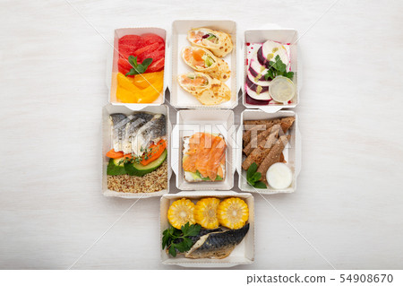 Set of healthy meals for the day in lunch boxes stands on a white table. Concept of menu of proper 54908670