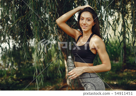 Beautiful sports girl in a summer park Beautiful sports girl in a summer park 54911451